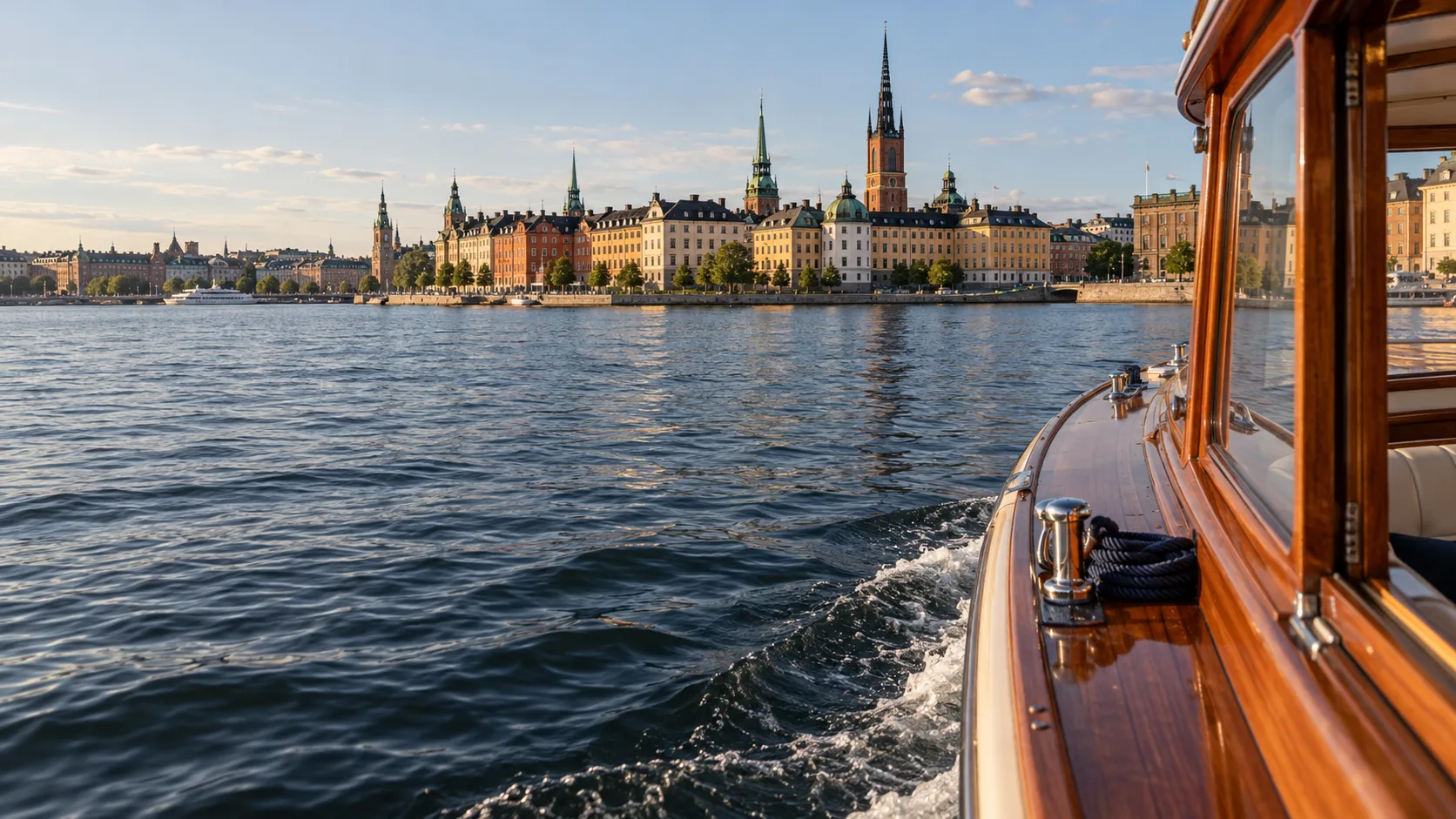 A wooden boat on the water with a city in the distance